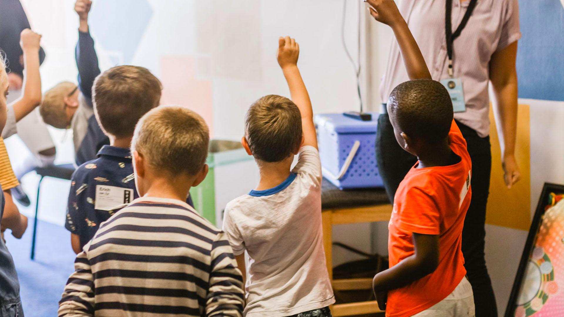 Students raising hand in classroom