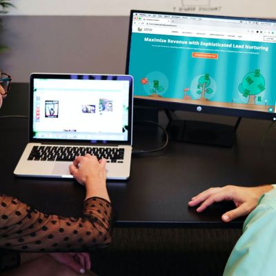 two teachers planning online learning on computers