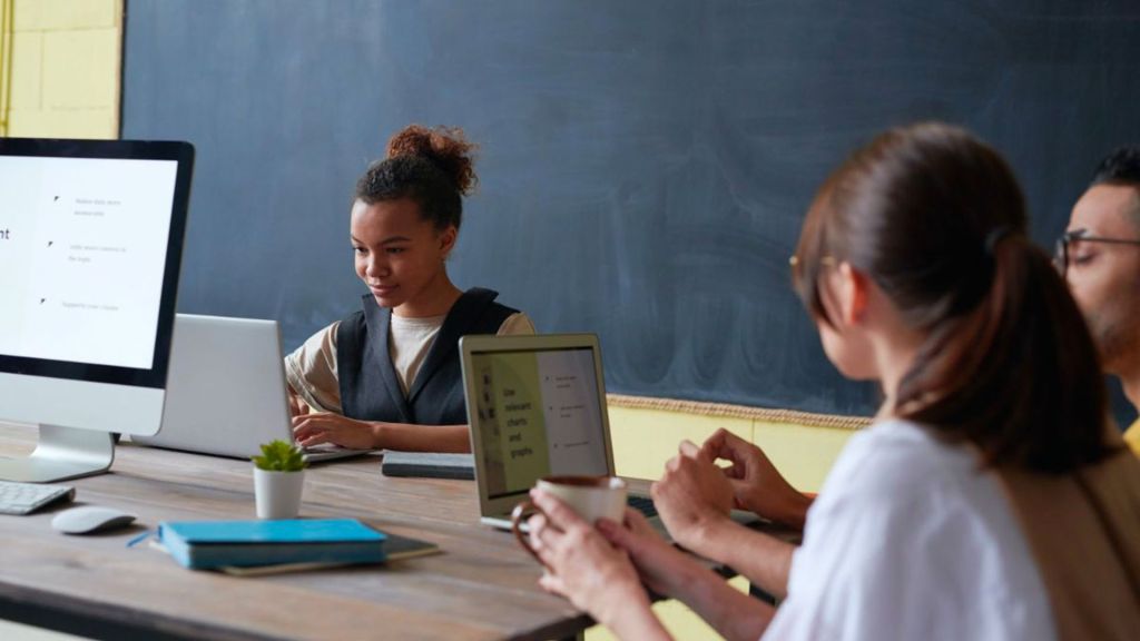 Keep IN Learning - Teaching Tech Habits students working together at computers in a classroom