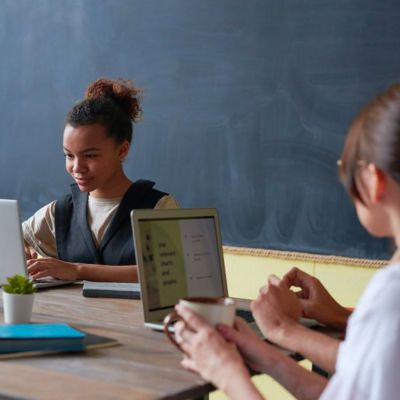 students working together at computers in a classroom
