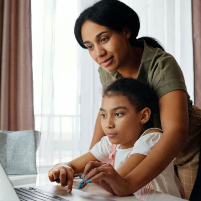 mom and her daughter working on a laptop