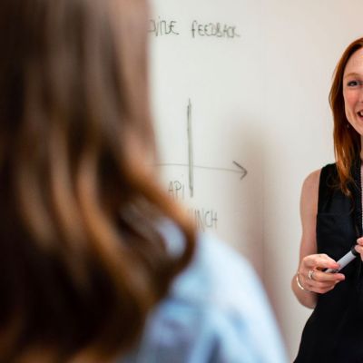 smiling teacher at a whiteboard