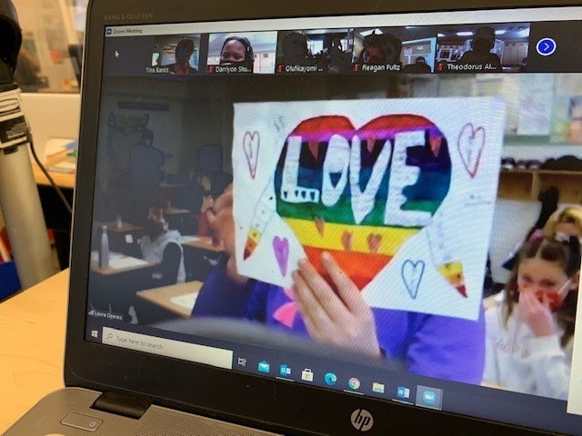 Zoom class - global connection zoom classroom with student showing off drawing