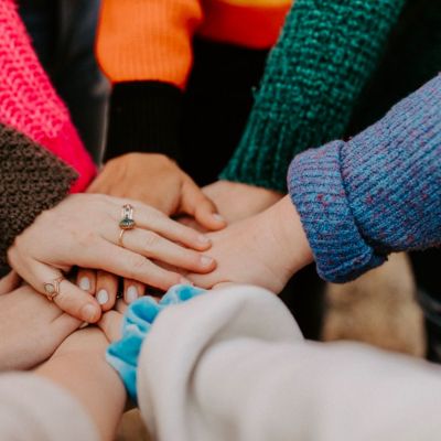 hands on top of each other together in a circle