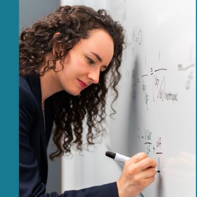 math teacher writing on whiteboard
