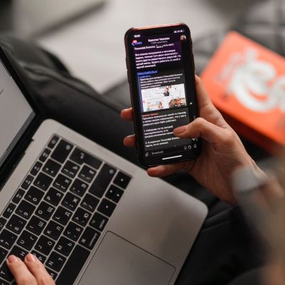 person using computer and phone