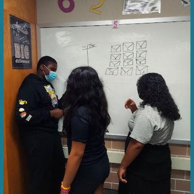 student's working at a whiteboard