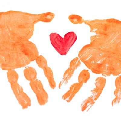painted handprints surrounding a heart