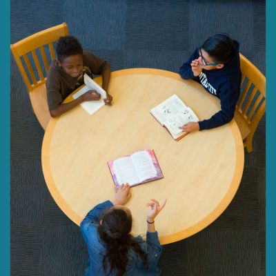 students reading at a table together