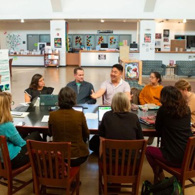 teachers meeting in a library