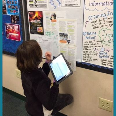 student working at an anchor chart