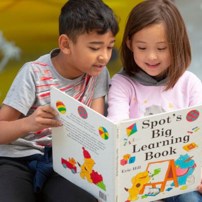 students reading a book together