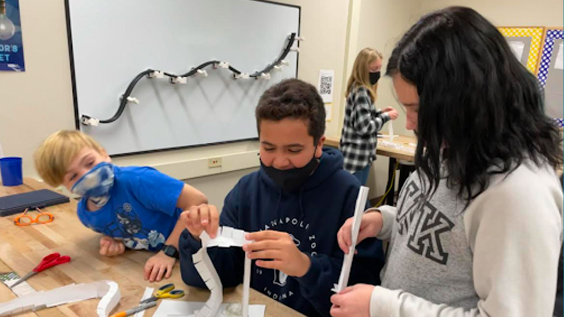 STEM - Students working on STEM project together Students working on a paper STEM projects