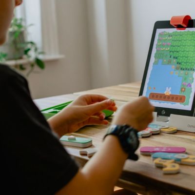 young boy playing a game on a tablet