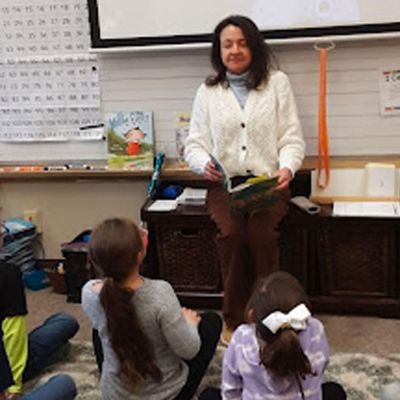 teacher and students doing a breathing practice