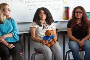 young girl holding a teddy bear