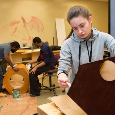 student building a wooden structure