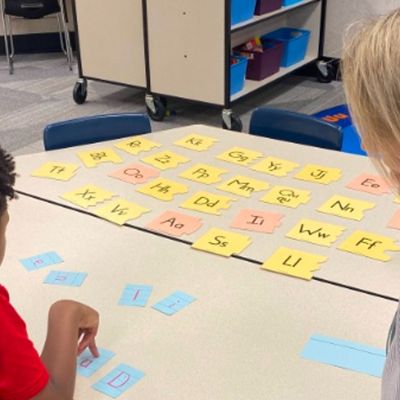 teacher and student working on flashcards