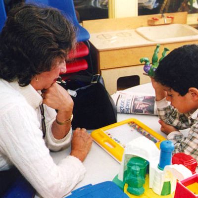 teacher working with a students sketching