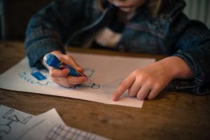 student drawing with a marker