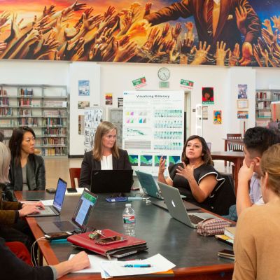 Teachers meeting in a library