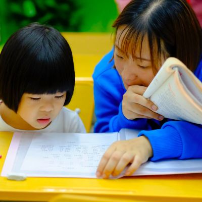 Teacher teaching a student.