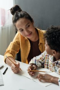 Woman teaching a child.
