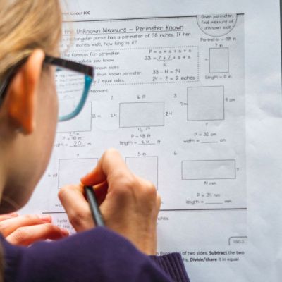 Woman filling out some problems on a worksheet