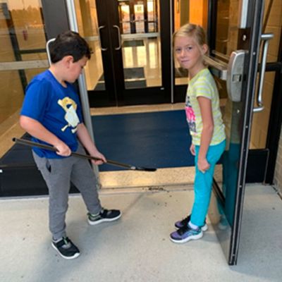Two students sweeping