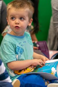Little boy holding a book.