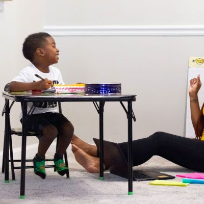 Woman teaching a child.