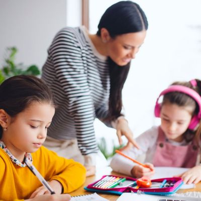 Children doing homework with an adult.