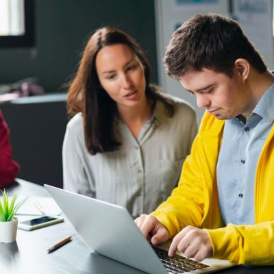 Students using a laptop in class.