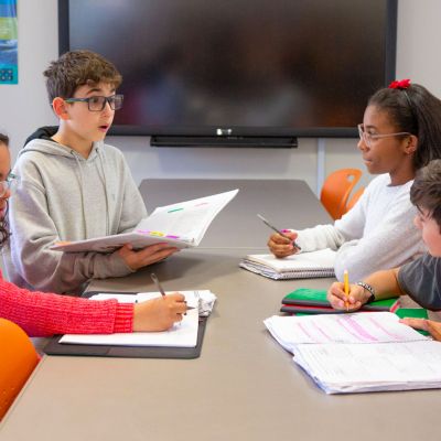 Two male middle schoolers and two female middle schoolers working