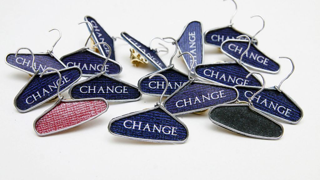 Paper clips into clothes hangers with the word 