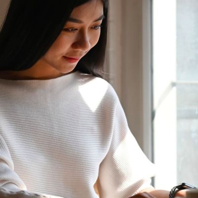 Woman working on a laptop at the table.