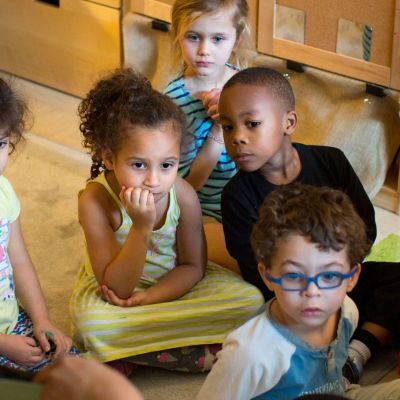 Children sitting and listening to a story.