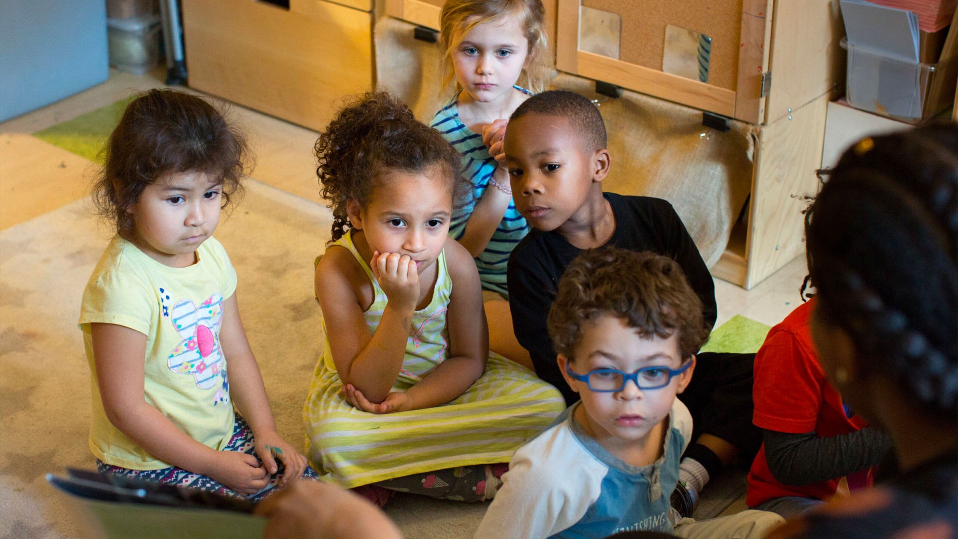 Children sitting and listening to a story.