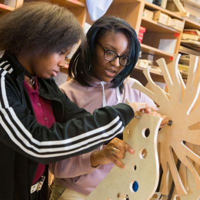 Students working on an engineering project made of wood.