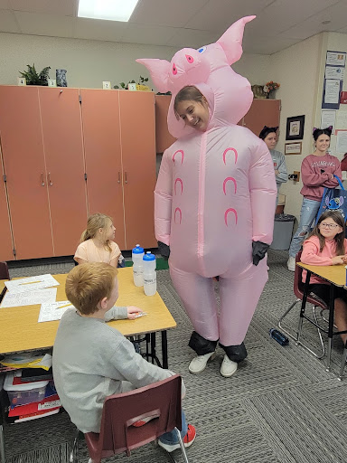 Reverse Trick or Treat 2 Student in costume with elementary students.