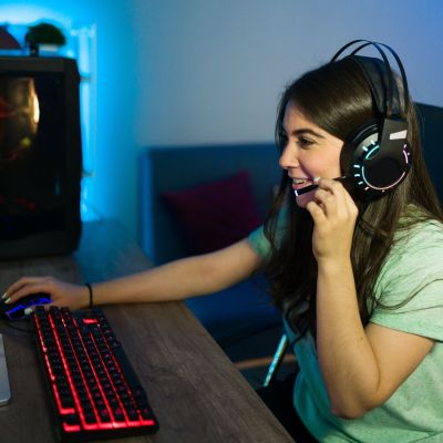 Person at a computer with a headset on.