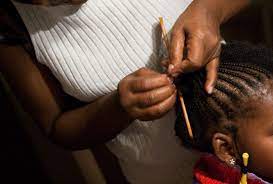 A girl getting her hair done.