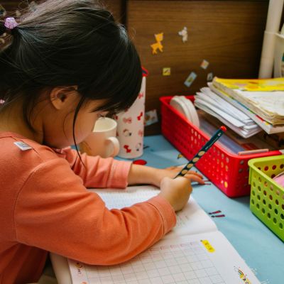 Little girl writing on paper.