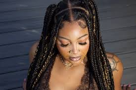A woman with braids posing for a picture.