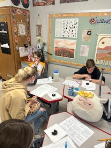 Students sitting at their desks in a classroom.