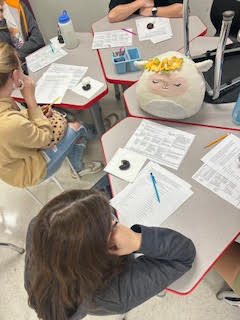 Students sitting at their desks in a classroom.