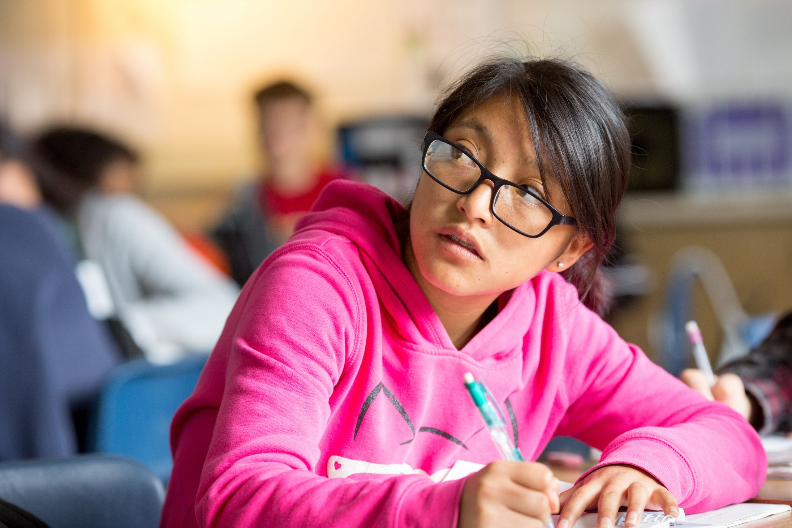 A student journals her response to a writing prompt in a tenth-grade English class.