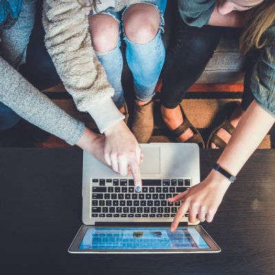 People pointing at a computer screen.