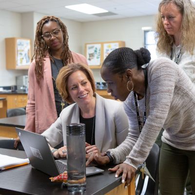 A middle school science team collaborates on their upcoming lessons.