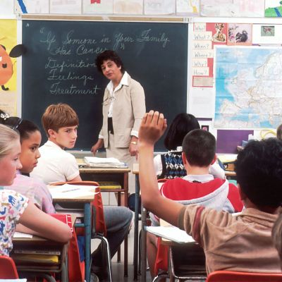 Students in a classroom with a teacher.